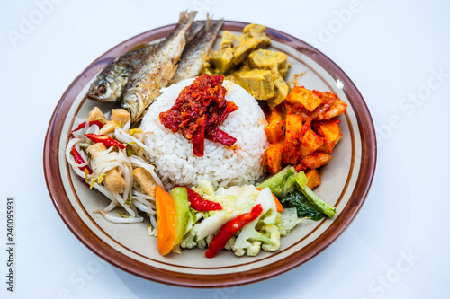 Indonesian style nasi campur with ikan goreng, gulai nangka, kentang balado, sayur capcay and tumis toge tahu