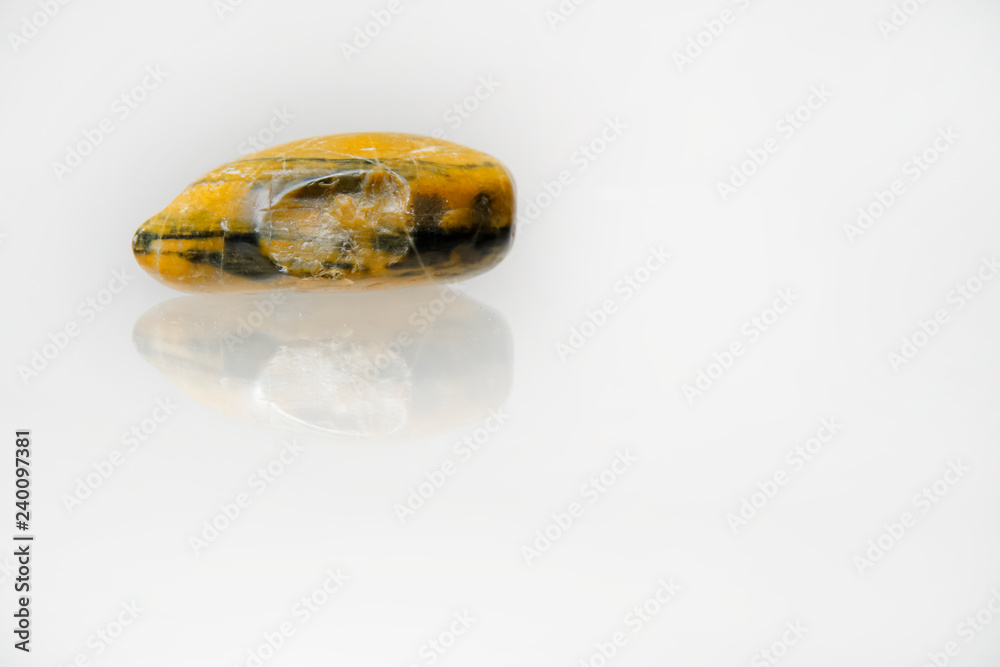 Beautiful pebble stones on a reflective white surface Beautiful pebble stones on a reflective white surface