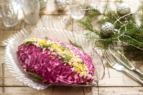 Obraz na płótnie Traditional Soviet festive salad of herring and vegetables, served with vodka in a New Year's decoration. Rustic style. w salonie