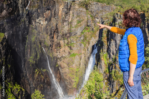 Tourist woman by Voringsfossen waterfall, Norway