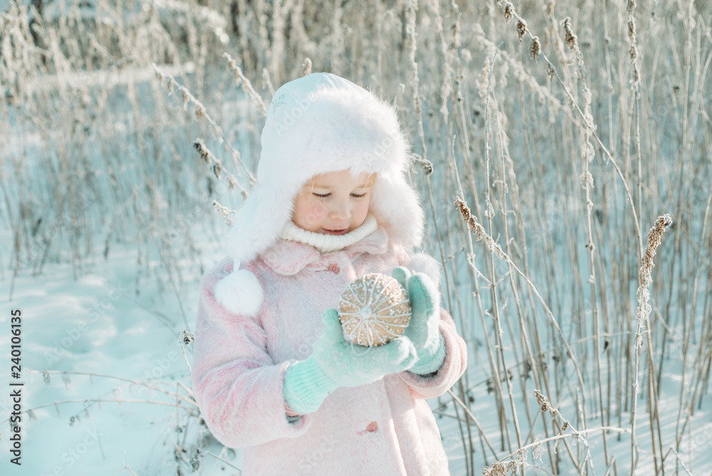 Little cute smiling girl with decoration ball outside Little cute smiling girl with decoration ball outside