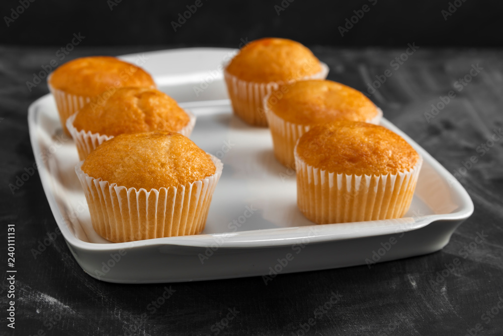 Cupcakes on a white plate on a dark background