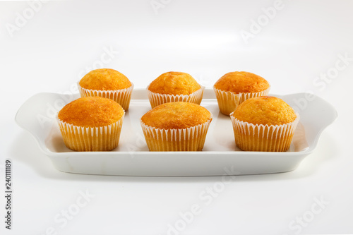 Cupcakes on a white plate on a light background