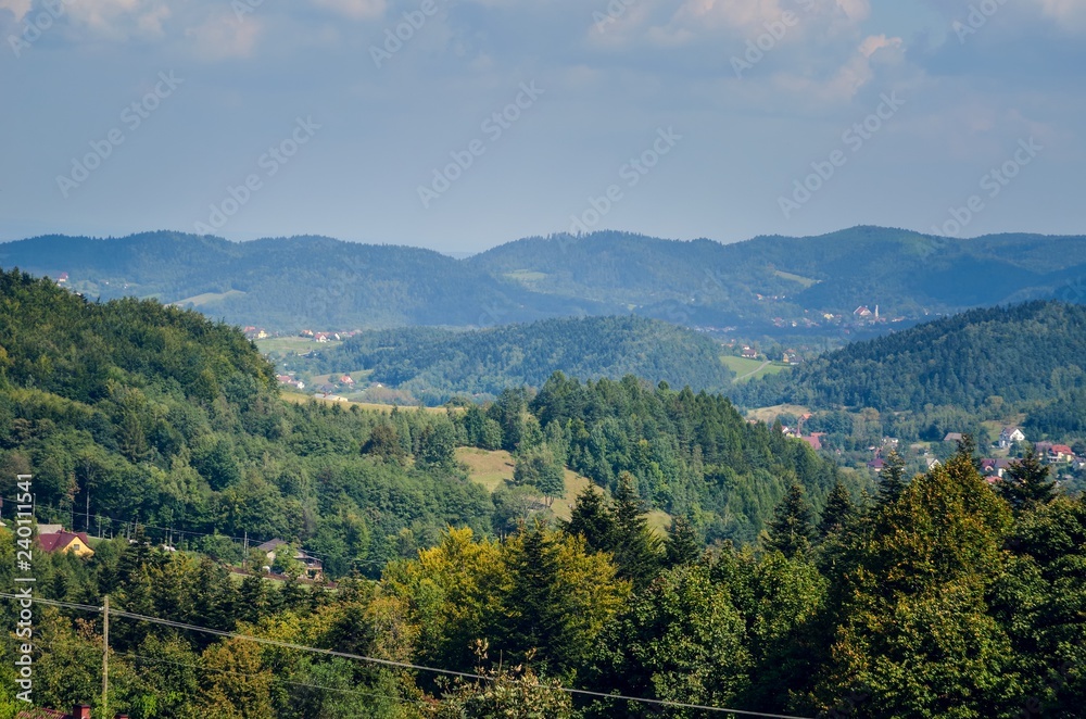 Beautiful rural mountain landscape. Cottages on the hills in the summer scenery.