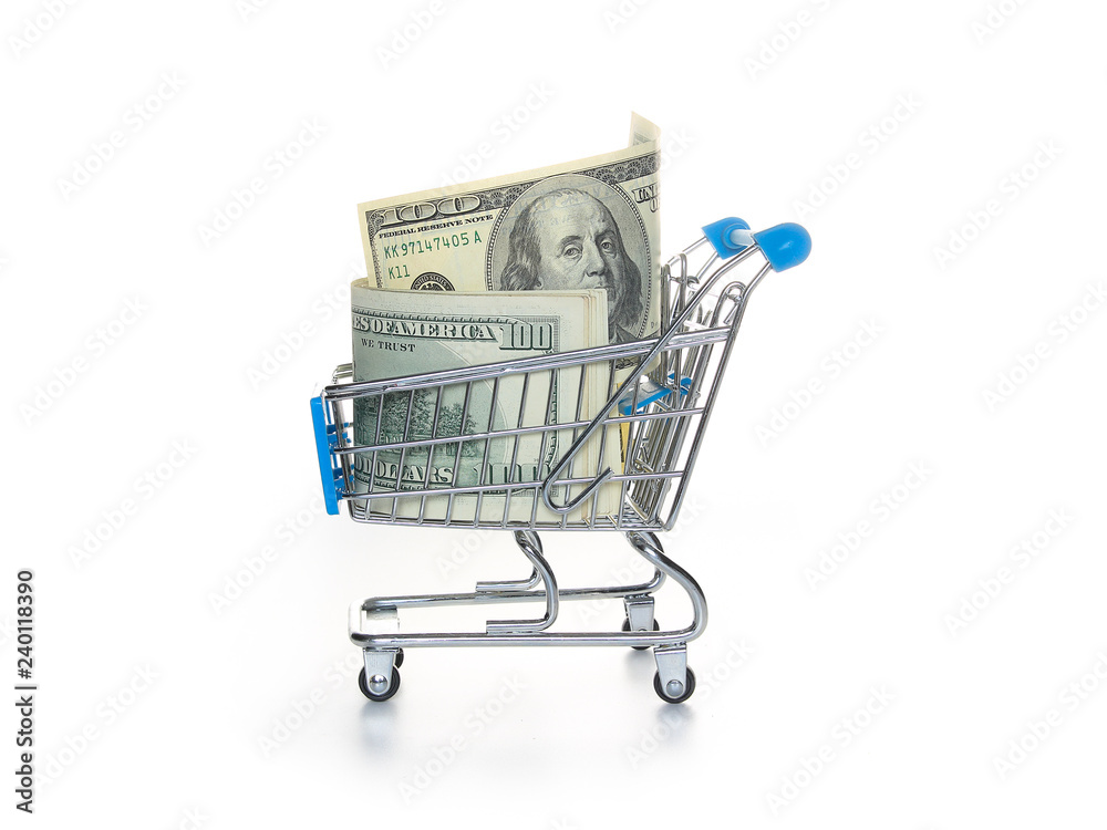 Banknotes one hundred dollars in a shopping trolley. The concept of exchange and purchase of currency.