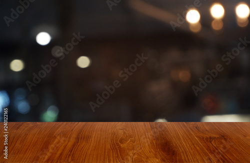 Empty dark wooden table in front of abstract blurred background of cafe and coffee shop interior. can be used for display or montage your products - Image.