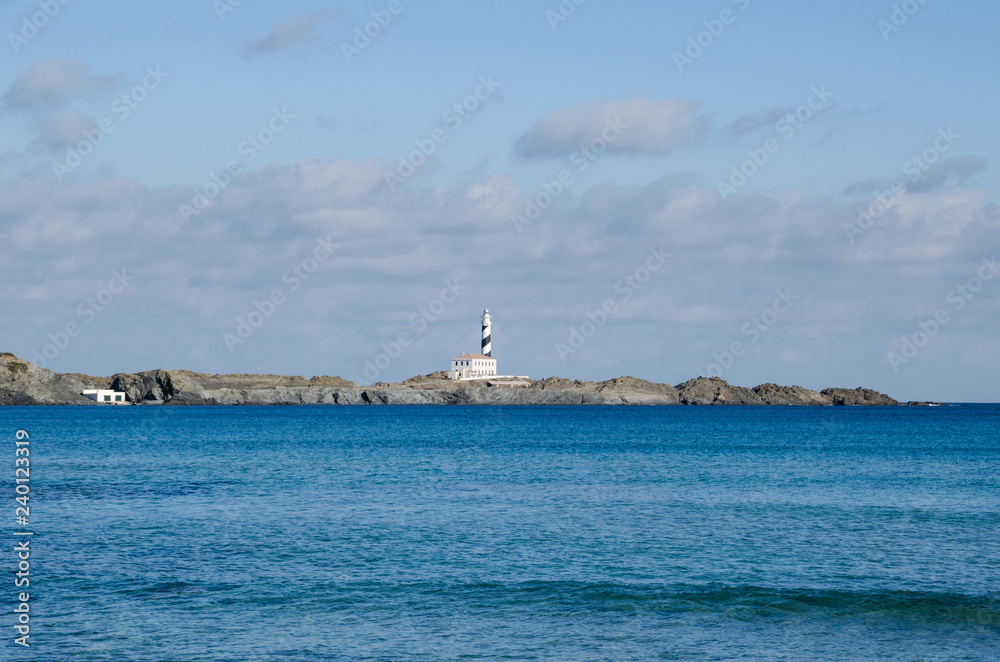 Photograph of a lighthouse in Menorca from a distance. Photograph of a lighthouse in Menorca from a distance.