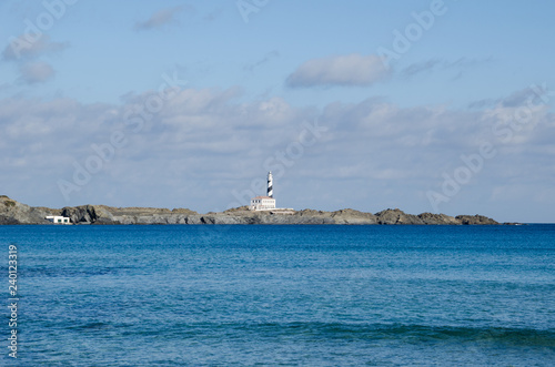 Photograph of a lighthouse in Menorca from a distance.