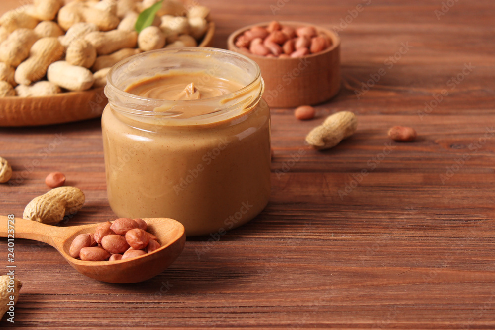 peanut butter and peanut beans on wooden background peanut butter and peanut beans on wooden background