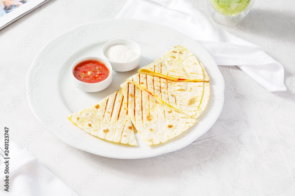 Quesadilla, quesadilla with cheese, meat on a plate on the table Quesadilla, quesadilla with cheese, meat on a plate on the table