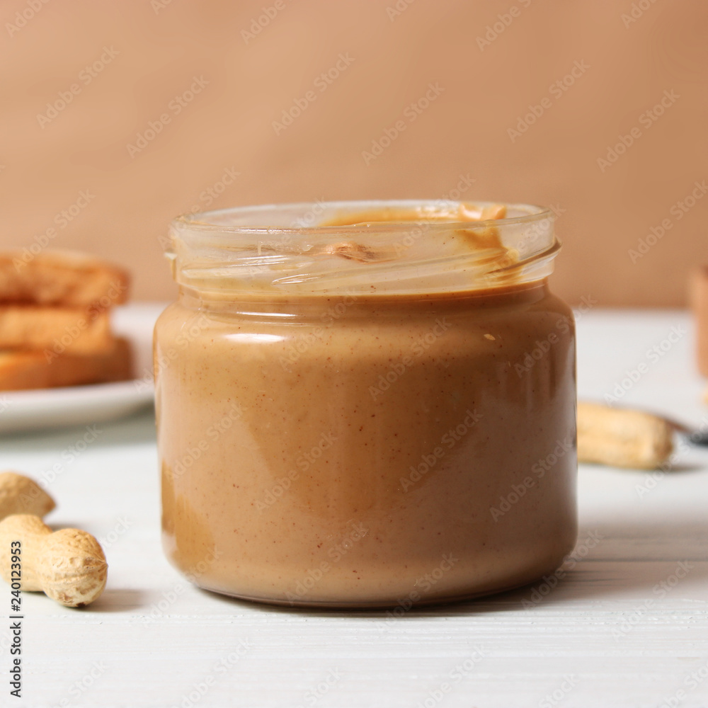 peanut butter and peanut beans on wooden background peanut butter and peanut beans on wooden background