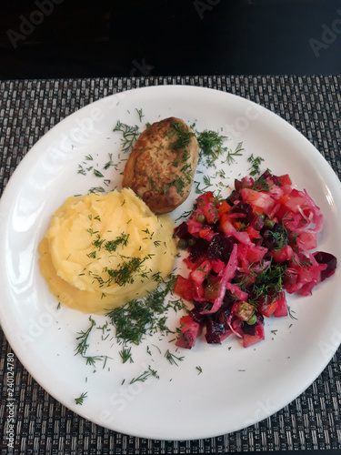 European homemade food. Lunch. Mashed potatoes, meat cutlet, vegetable salad - vinegret. Vinaigrette - salad with beets and other boiled and marinated vegetables.