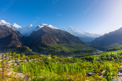 Scenic view of Hunza Valley in summer between the Karakoram Mountain range in Pakistan photo