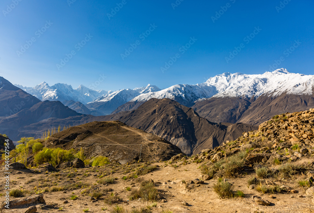 Scenic view of Hunza Valley in autumn between the Karakoram Mountain range in Pakistan Scenic view of Hunza Valley in autumn between the Karakoram Mountain range in Pakistan
