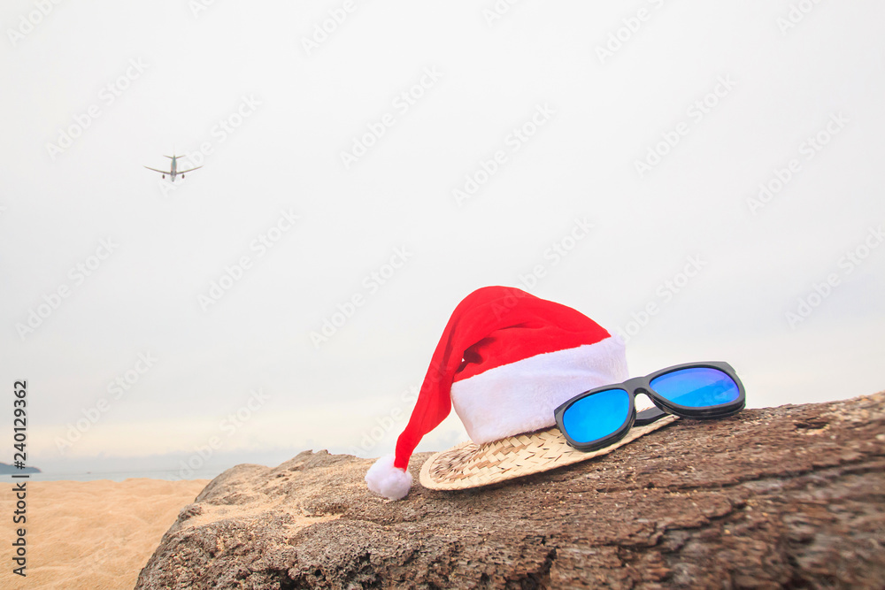 Christmas  Concept,A plane summer holiday background, Beach accessories on the beach, Vacation and travel items,In tropical Phuket Thailand.