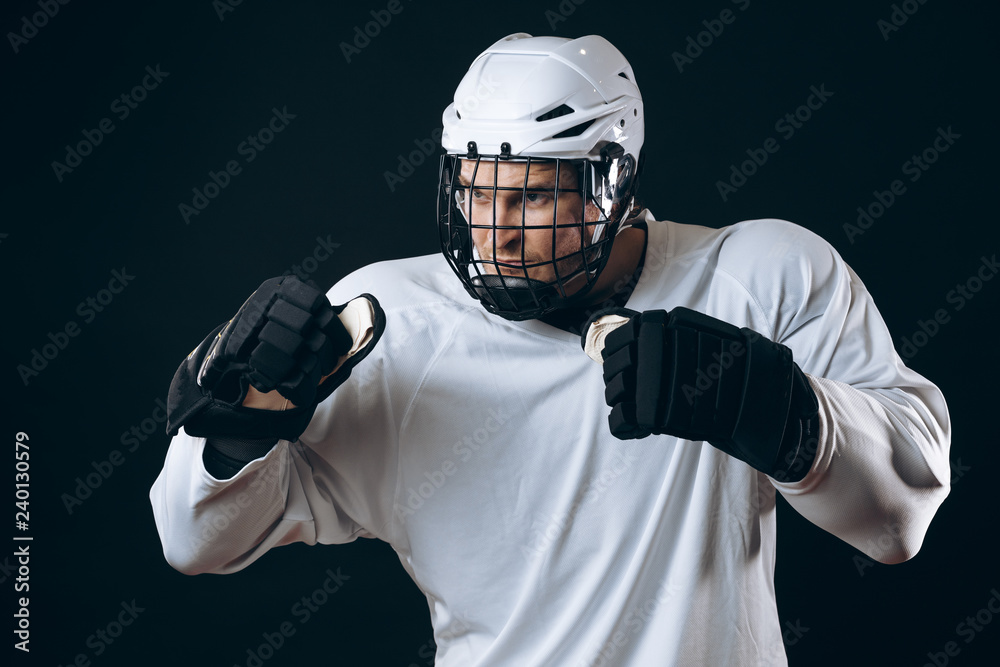 Obraz premium Emotional outraged ice-hockey player man gestures angrily, being provoked with the enemy, standing in fight pose. Sport, Negative emotions and rivalry concept