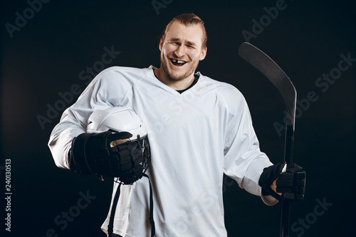 Handsome hockey player smiling at camera with one missing tooth, asking the supporters if there is so any interest in going to that hockey game