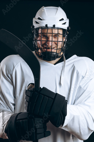 Canvas Print Head and shoulder portrait of confident brave hockey player in white uniform with protective helmet looking at camera, being sure in his team s victory