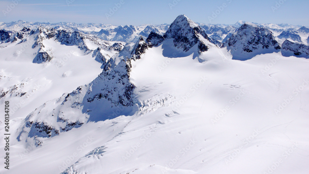 winter mountain landscape in the Silvretta mountain range in the Swiss Alps with famous Piz Buin mountain peak in the center winter mountain landscape in the Silvretta mountain range in the Swiss Alps with famous Piz Buin mountain peak in the center
