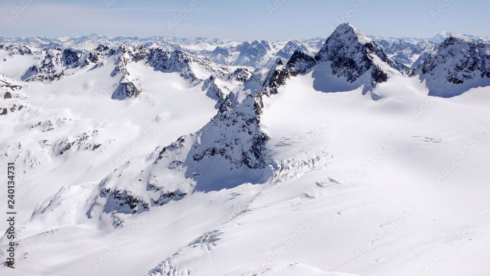 winter mountain landscape in the Silvretta mountain range in the Swiss Alps with famous Piz Buin mountain peak in the center