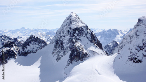 winter mountain landscape in the Silvretta mountain range in the Swiss Alps with famous Piz Buin mountain peak in the center photo