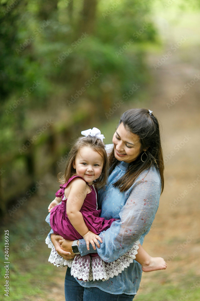 Mom holding preschool toddler daughter girl with strong bond and love Mom holding preschool toddler daughter girl with strong bond and love