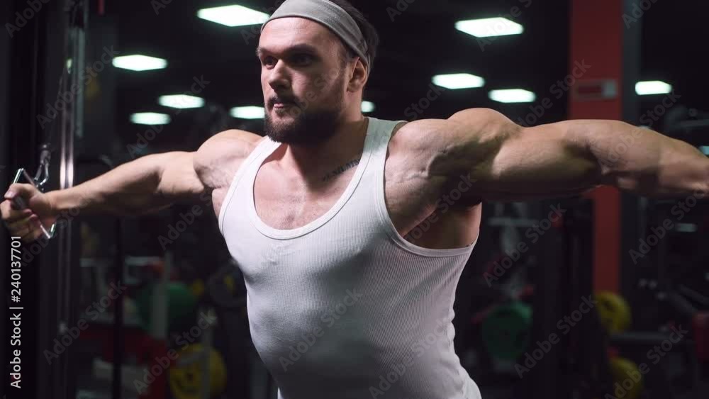 Brutal strong athletic men pumping up muscles workout bodybuilding sport nutrition concept background - muscular bodybuilder handsome men doing exercises in gym naked torso 4k