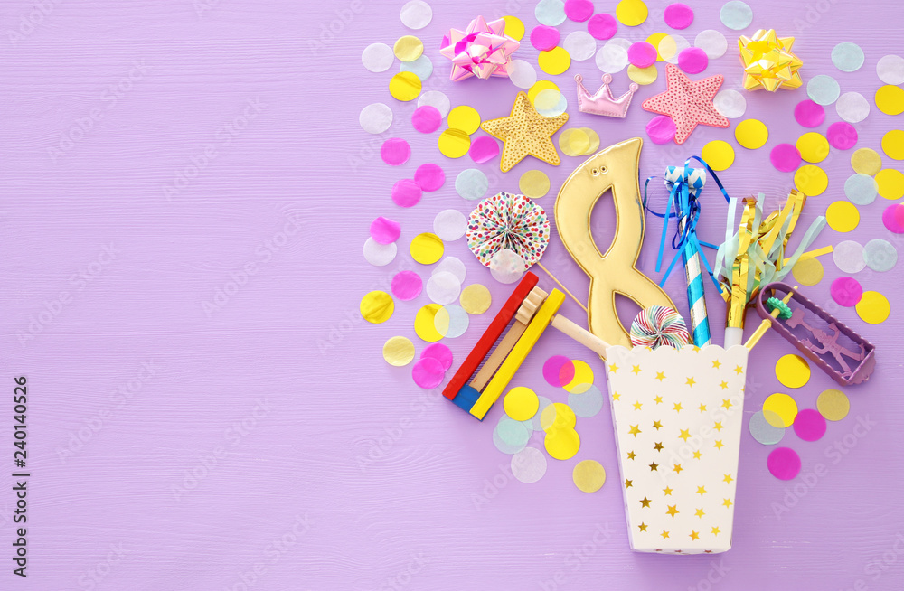 Purim celebration concept (jewish carnival holiday) over purple, pink wooden background. Top view. Purim celebration concept (jewish carnival holiday) over purple, pink wooden background. Top view.