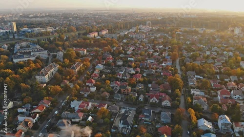 View from the height of the city on the roofs of houses, trees, mountains in the Cloudy sky. Cloudy sky. photo