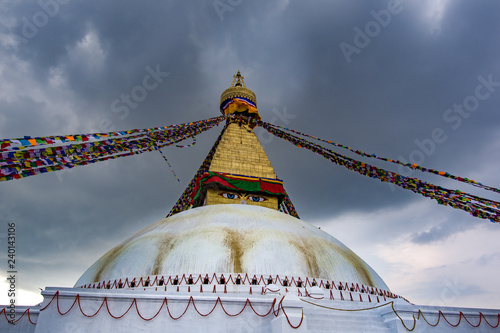 Landscape front view of Boudhanath Stupa and prayer flags. Kathmandu, Nepal. Boudha Stupa is one of the largest stupas in the world.