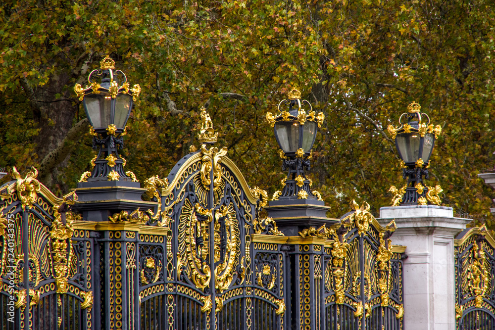 Close up view of golden details on black fence. London, England.