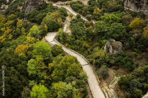 Fototapeta Naklejka Na Ścianę i Meble -  aerial photography landscape view of narrow paved and curved road for walking and promenade in mountain forest highland scenic environment tourist world heritage site in central Asia