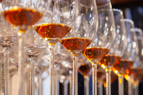 Obraz na plátně Closeup glasses with cognac stand in line