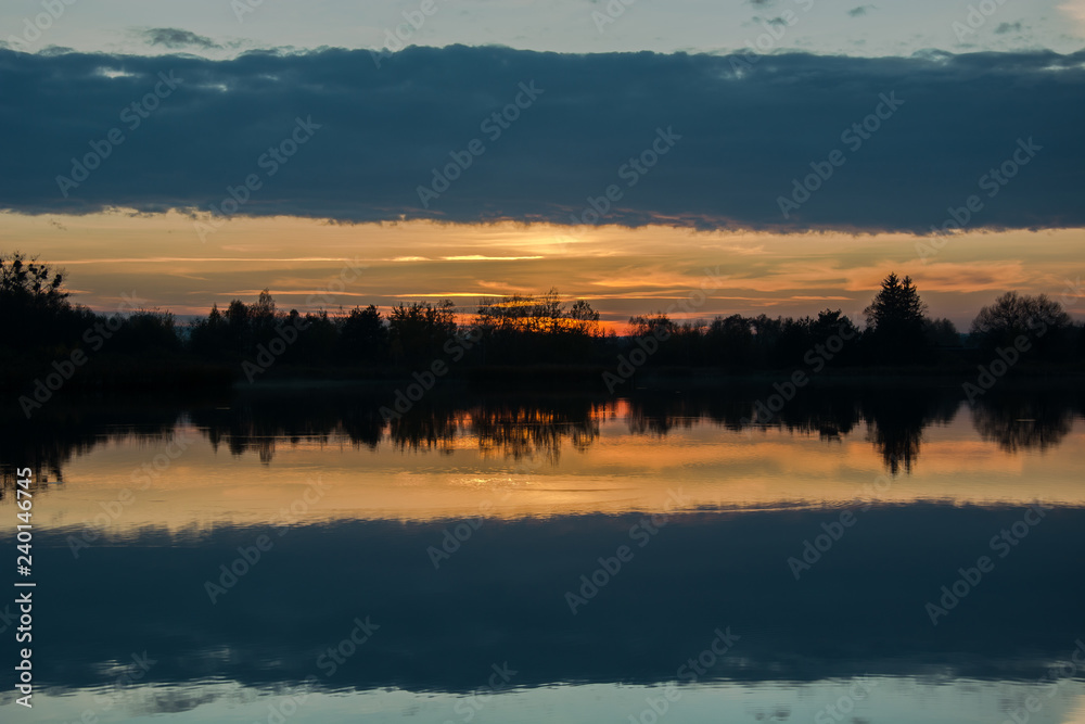 Fototapeta premium Dark cloud reflecting in the lake