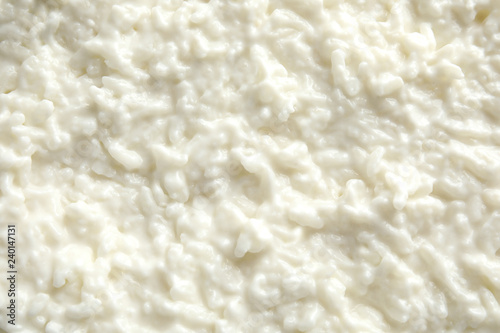 Delicious creamy rice pudding as background, top view photo