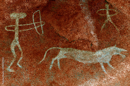 image of ancient hunters on the cave wall. history of antiquities, archaeologist.