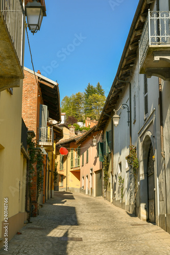 Fototapeta Naklejka Na Ścianę i Meble -  Street view of an old Italian village with the typical colored buildings in spring, Monforte d'Alba, Langhe, Piedmont