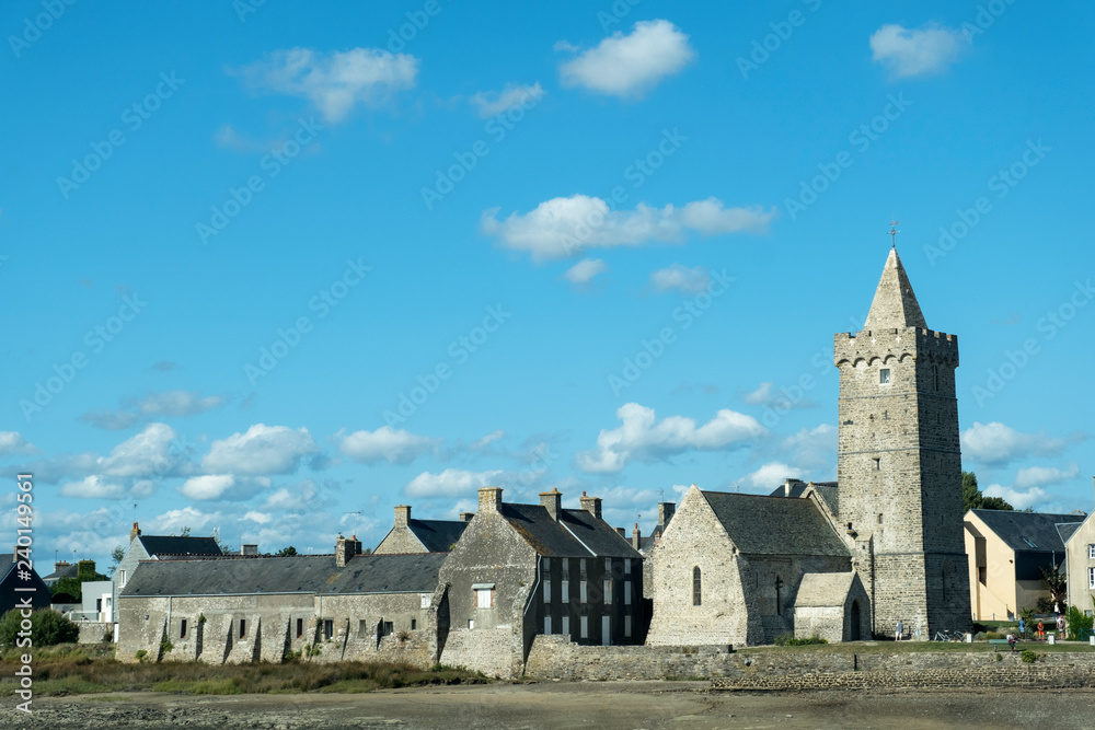 View of the Church Notre-Dame with fortified bell tower in Portbail. Normandy, France