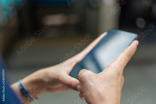 woman s hand holding smart phone with blur background. selective focus and soft focus.