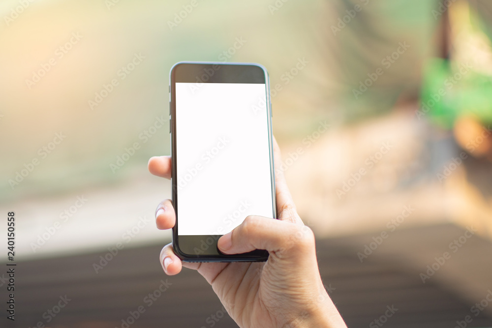 woman's hand holding smart phone with blur background. selective focus and soft focus. woman's hand holding smart phone with blur background. selective focus and soft focus.