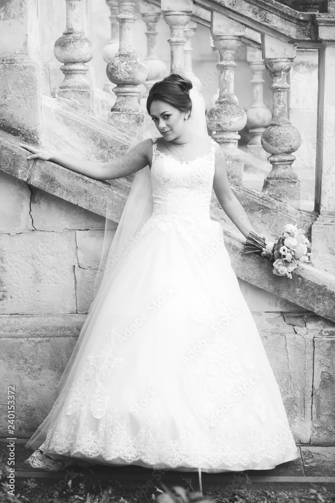 Beautiful european bride walking near old castle and have fun Beautiful european bride walking near old castle and have fun