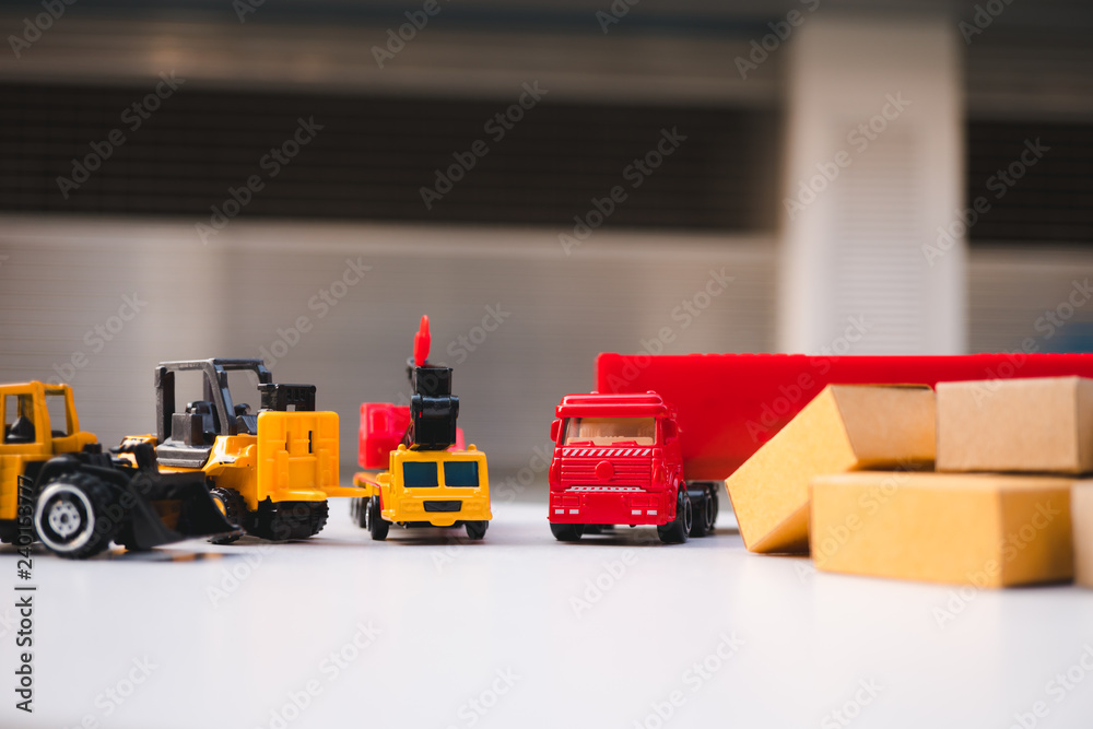 Fototapeta premium Construction vehicles and cardboard boxes using as logistics concept
