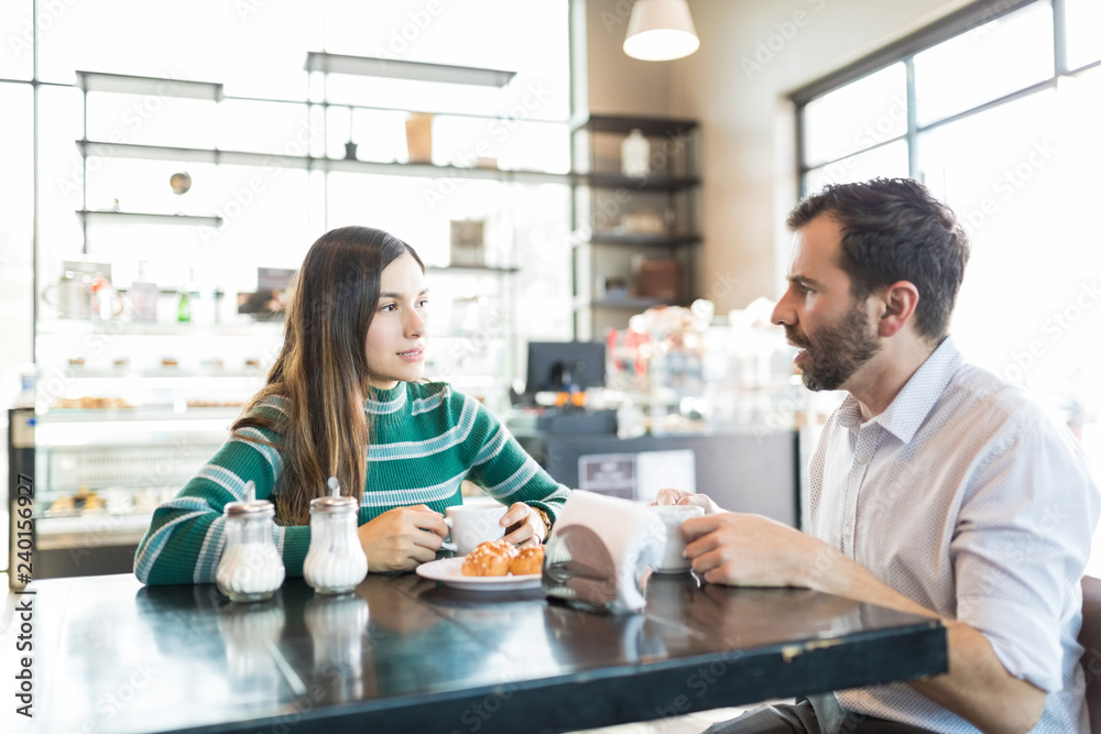 Couple Having Serious Discussion In Cafe Couple Having Serious Discussion In Cafe