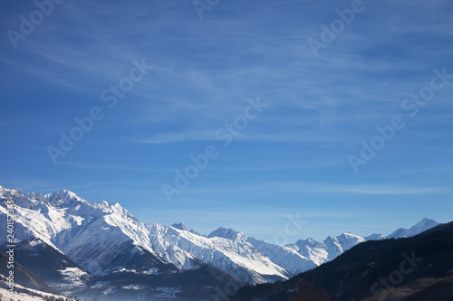 View on snowy mountains and beautiful blue sky in nice sunny morning © BSANI