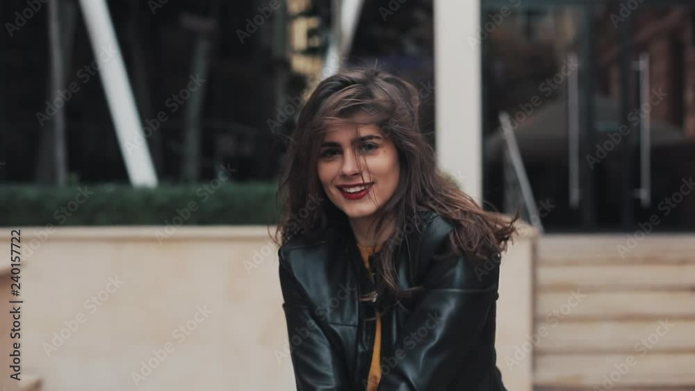 Happy young woman walking on the street and moving in dance. Slow motion Happy young woman walking on the street and moving in dance. Slow motion
