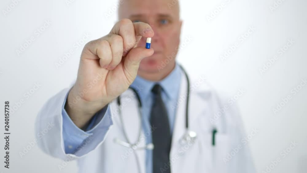 Doctor Recommending New Medical Treatment Showing in His Hand One Colored Pills Doctor Recommending New Medical Treatment Showing in His Hand One Colored Pills