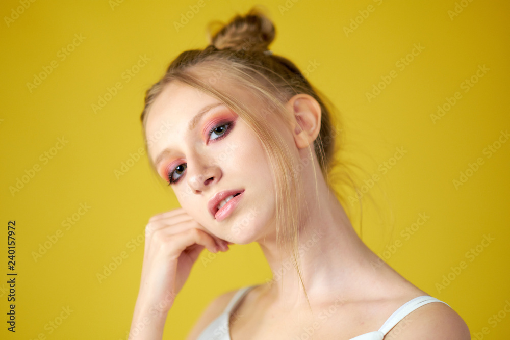 young girl on a yellow bright background. beautiful makeup, bright image, place for text young girl on a yellow bright background. beautiful makeup, bright image, place for text
