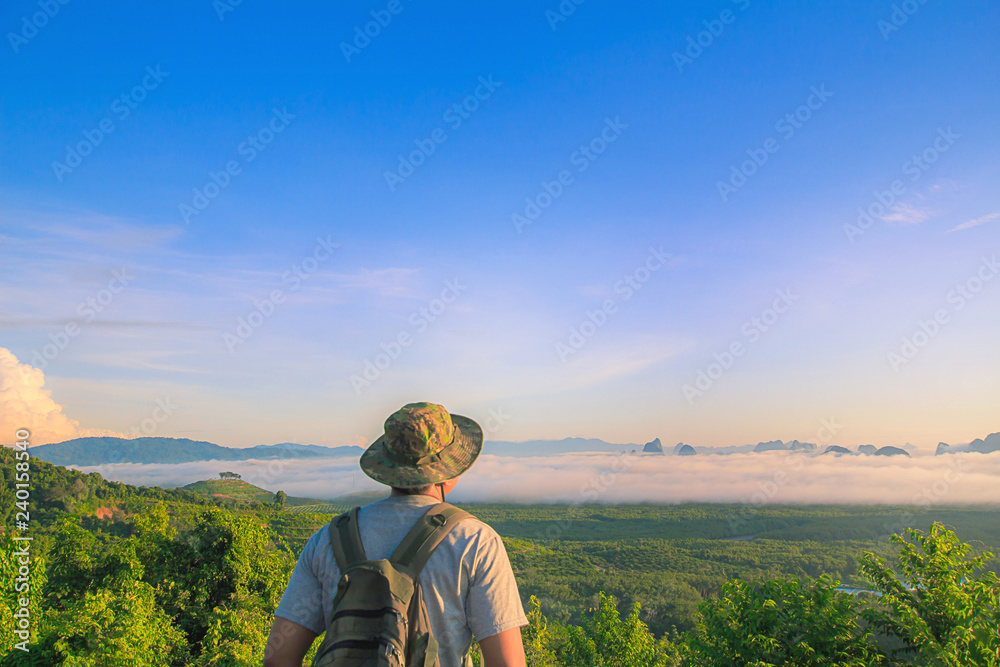 Men's Travel adventure, backpacking . Morning light tour with mountains near the sea, Samed Nang Chee viewpoint tropical zone in Phang Nga Thailand.
