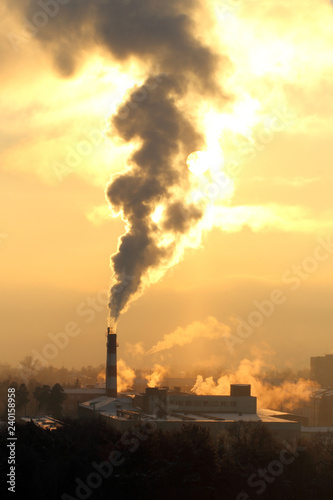 Smoke from the chimney and air pollution. Factory in the city. Industry. 
