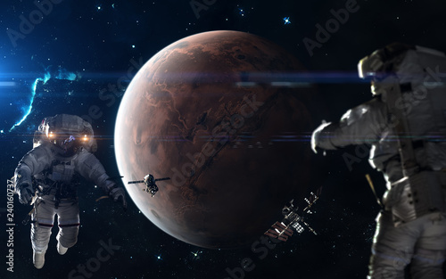 Fototapeta Naklejka Na Ścianę i Meble -  Colonization of Mars. Astronauts, space stations in Mars orbit. Science fiction art. Elements of the image were furnished by NASA